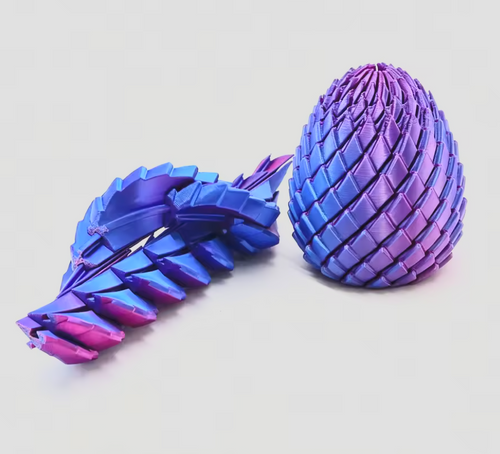 Two 3D-printed articulated toy models, one egg-shaped and one leaf-like, featuring a vibrant blue, purple, and pink iridescent gradient finish, displayed on a clean light gray background.